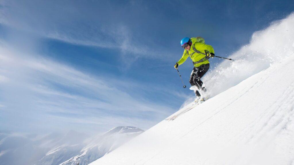 A man skiing down a steep slope
